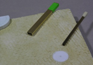 Tools used to stamp cobblestones into wet water putty.